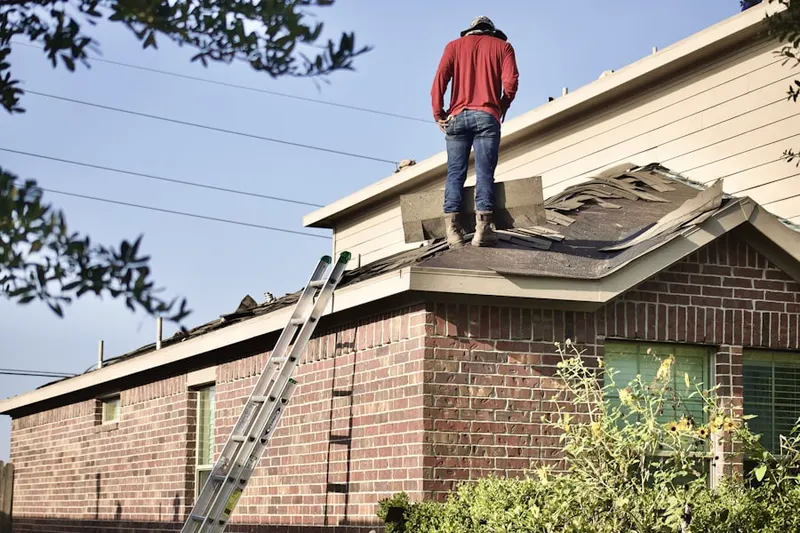 Professional roofer working on a residential roof in Atlantic Beach Estates